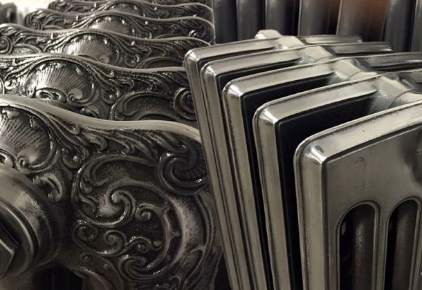 Close-up of ornate embossed patterns on restored cast iron radiators by Blast Spray Polish.