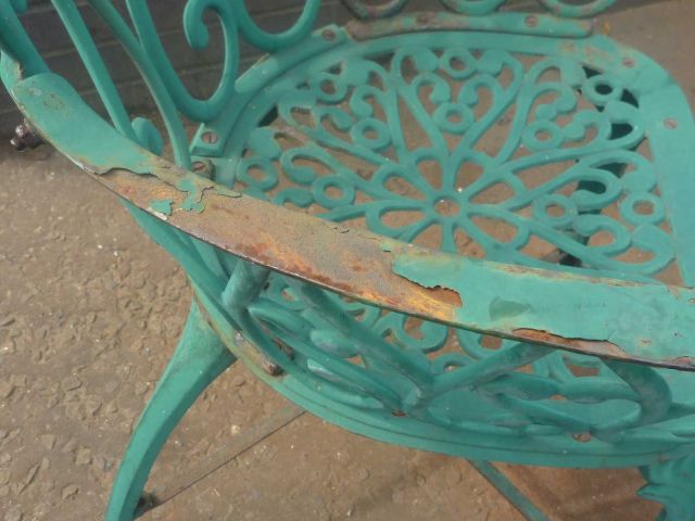 Teal garden chair with rust damage and peeling paint, in need of garden furniture restoration by Blast Spray Polish